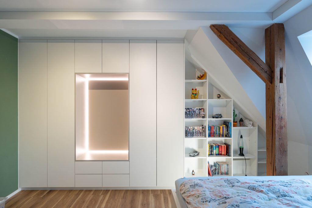 Frontalansicht Dachschrägenschrank matt weiß mit grauem Inlay als Sitzelement